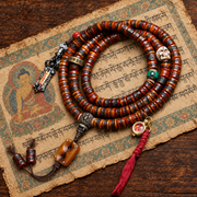 EverestArtstudios Yak Bone 108-Bead Mala with Wealth Deity and Mantra Motifs — styled on wood with a scripture display prop