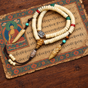 EverestArtstudios Golden-Tone Camel Bone 108-Bead Mala with Carved Accents — styled on wood with a scripture display prop