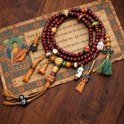EverestArtstudios Cut Bodhi Seed 108-Bead Mala with Pixiu and Vajra Motif Charms — styled on wood with a scripture display prop