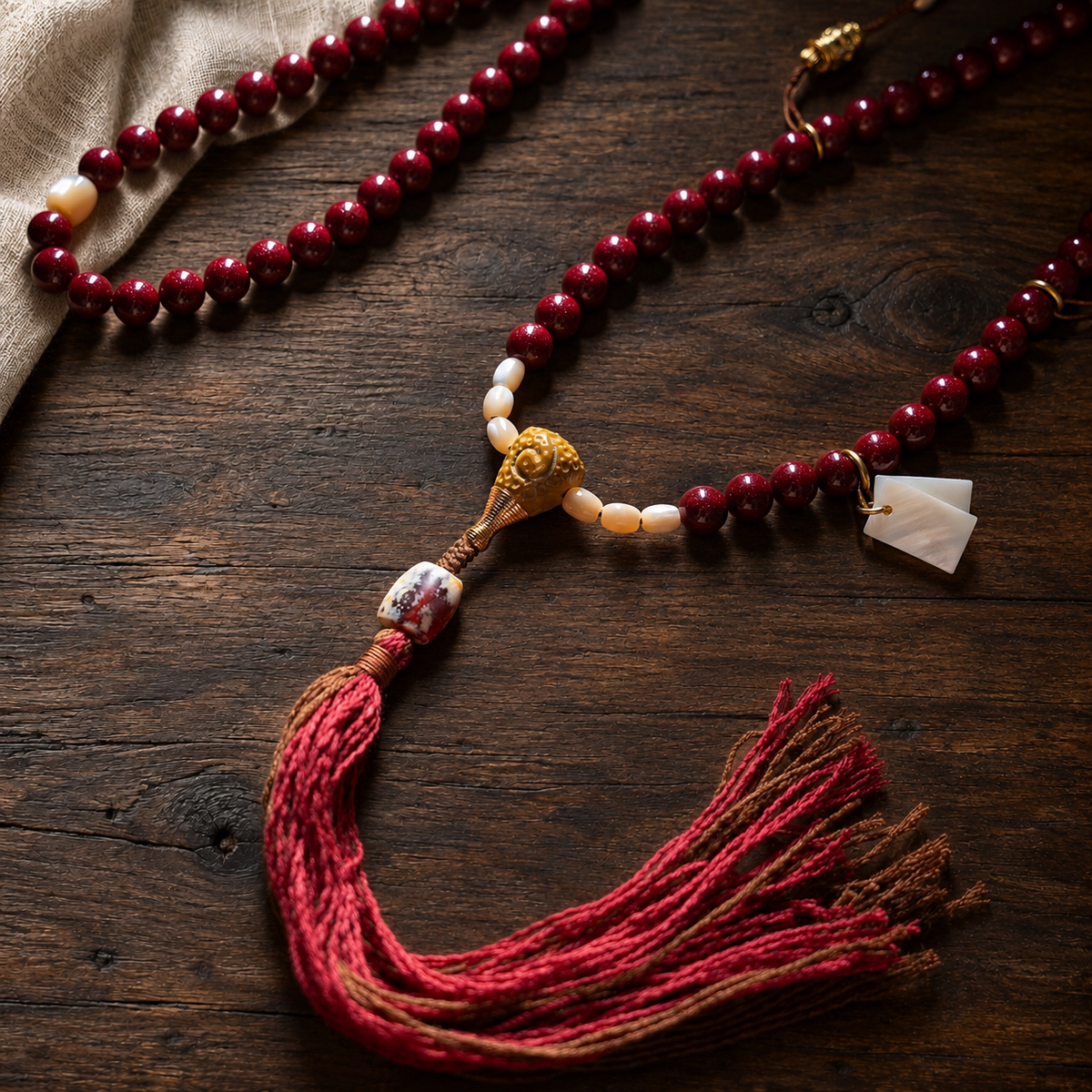 02 tassel detail — red cinnabar composite 108-bead mala