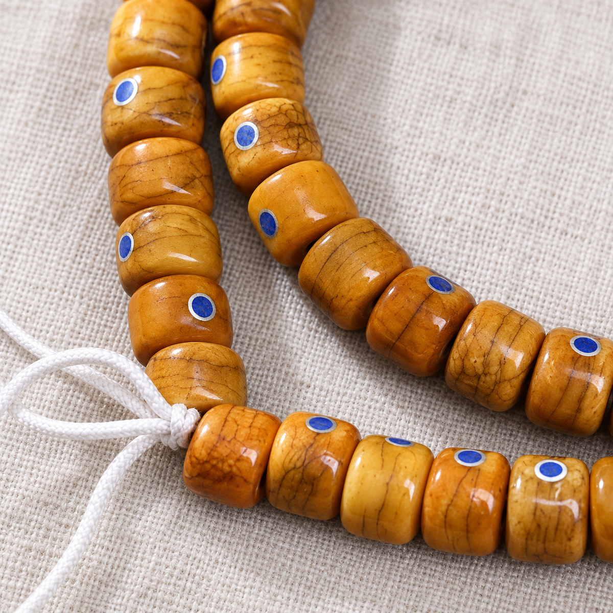 EverestArtstudios Aged Camel Bone and Lapis Inlaid Barrel-Bead 108-Bead DIY Strand — grain detail