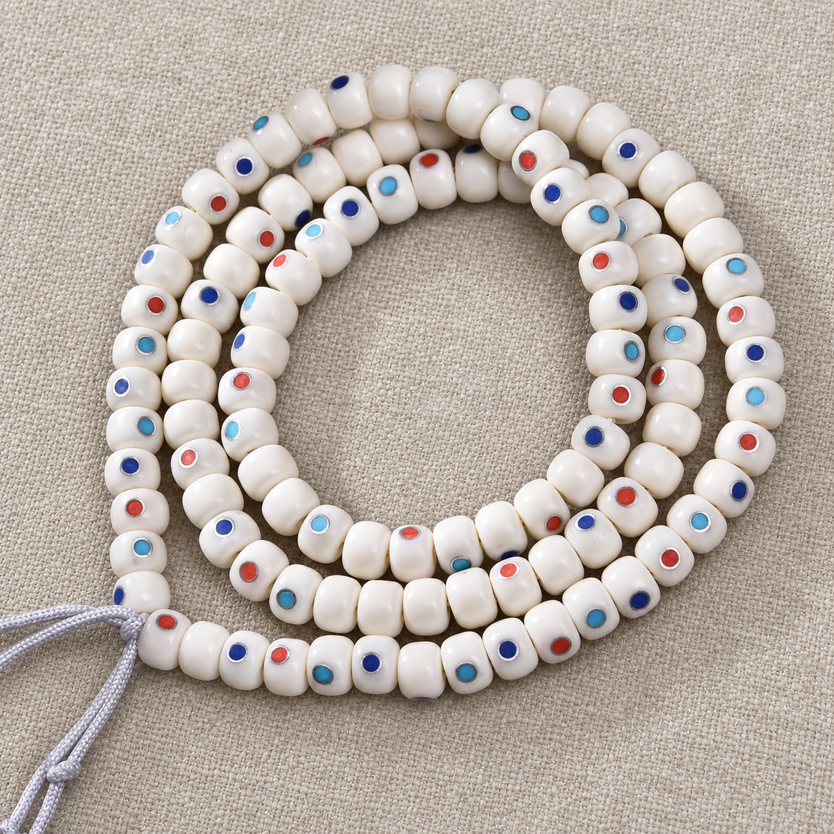 Fil 108 perles os de chameau et motif Wan